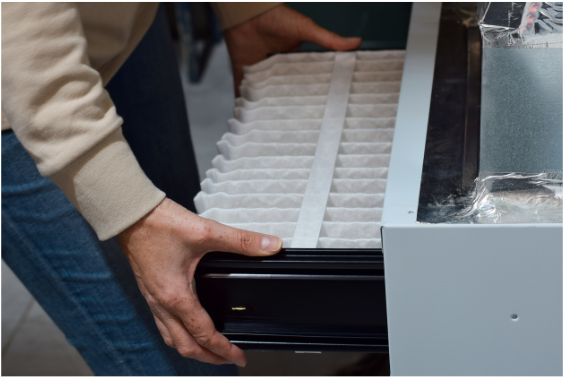 person changing a furnace filter